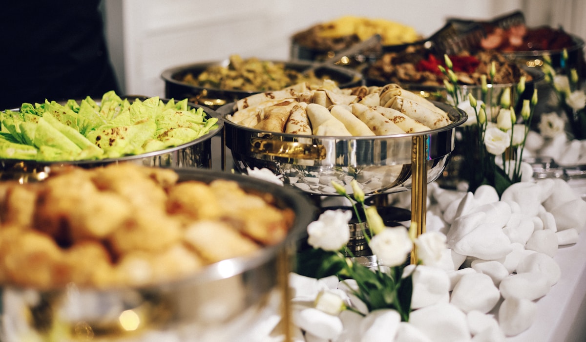 Large-scale catering setup with multiple service counters at an institutional event